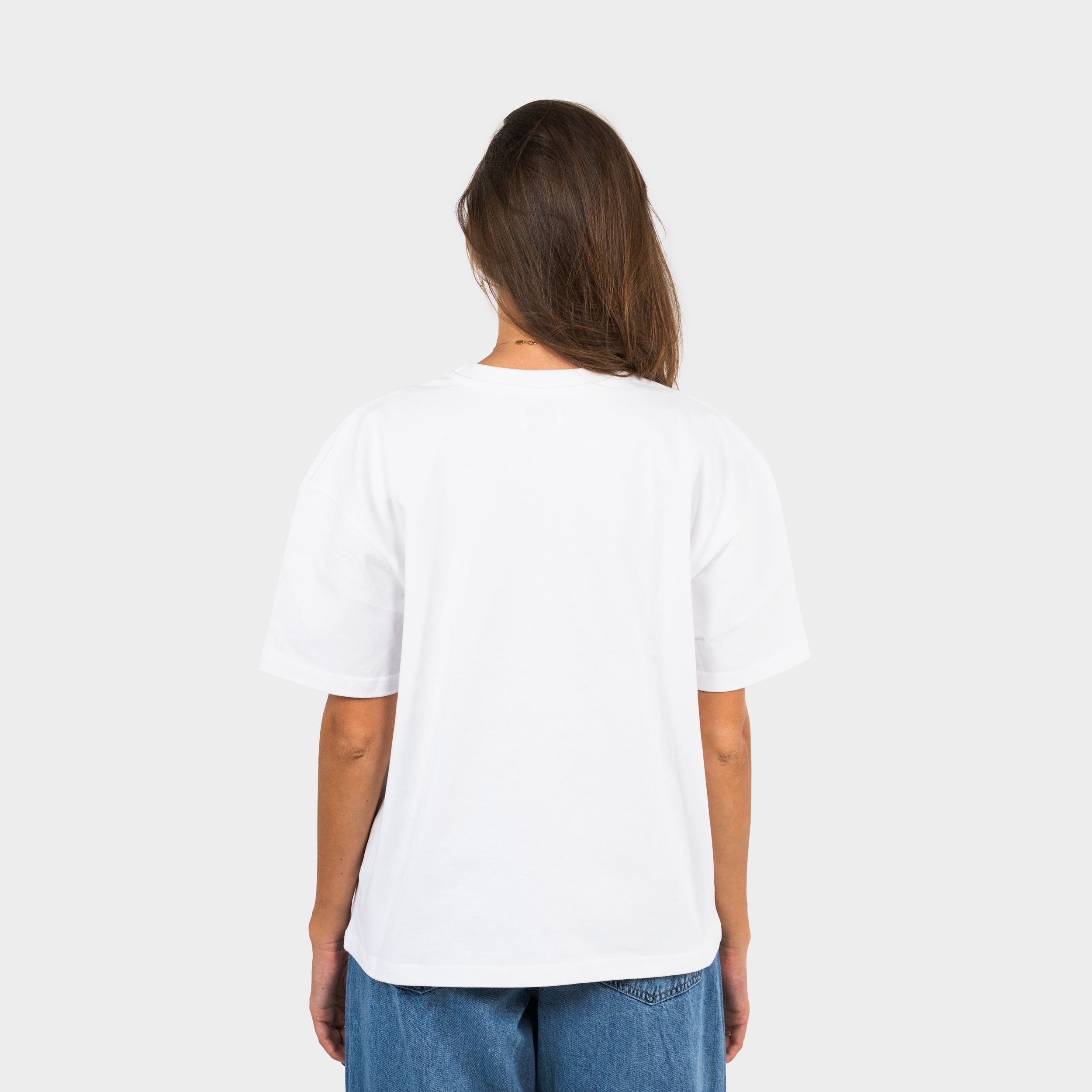 Woman wearing a white 'taze studios' t-shirt on a white background